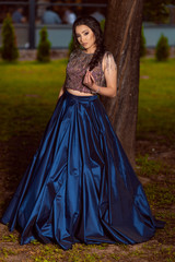 Fototapeta premium Beautiful young lady in luxury blue dress for her prom night