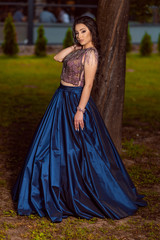 Beautiful young lady in luxury blue dress for her prom night