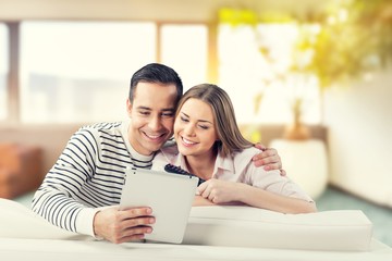 Fototapeta premium Young business couple using laptop at home, online shopping with credit card