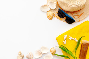 Straw hat, sun glasses, suncream, shells and plant leaves for sea vacation on white background top view mockup