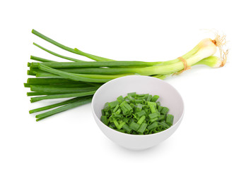 chopped green onion in the white bowl with fresh green onion isolated on white background