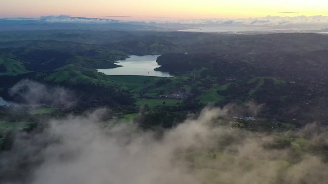 At sunrise, clouds drift over the San Francisco Bay area in California.