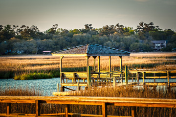 A covered dock on a creek in a salt-marsh in the low country of South Carolina.