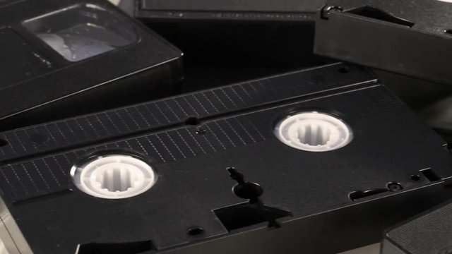Slow camera pan across retro VHS video tapes