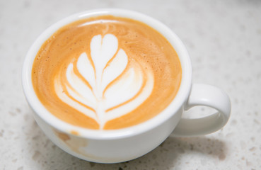 coffee cup latte art on the white marble table- Image 