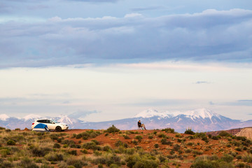 Man car camping with tent in beautiful wilderness landscape, Canyonlands National Park, Utah, United States
