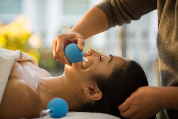 Young Woman receiving facial rejuventation cupping  in spa wellness center