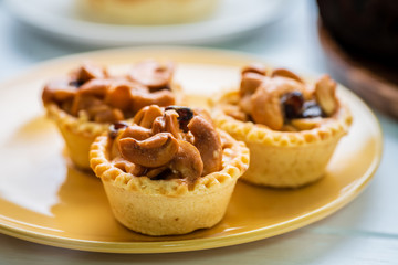 cashew nut tart on white wooden table
