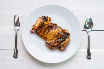Close up of grilled chicken in white plate