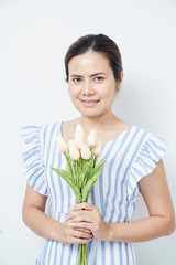 Beautiful woman holding bouquet of tulips