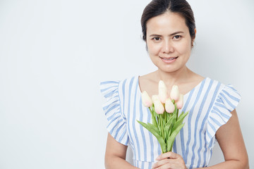 Beautiful woman holding bouquet of tulips