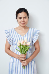 Beautiful woman holding bouquet of tulips