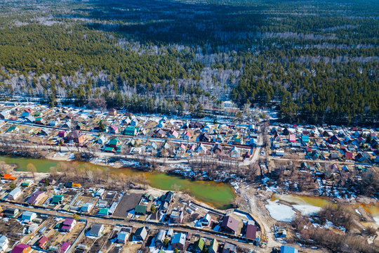 Aerial drone view of an old traditiona village in the forest, on background bly sky.