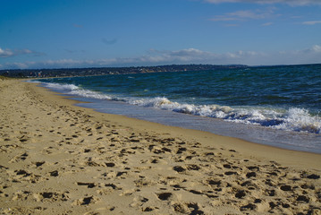 Seashore with blue water and clear sky
