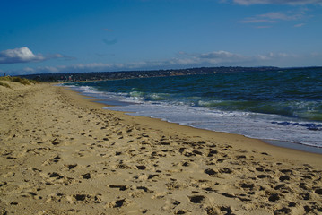 Seashore with blue water and clear sky