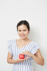 Woman holding red heart shaped