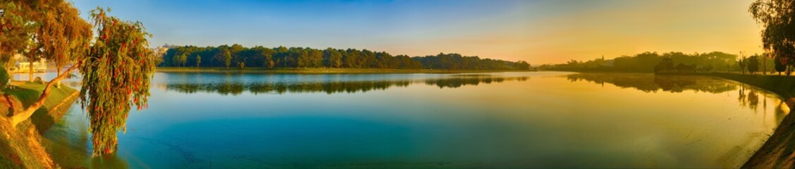 Fototapeta na wymiar Sunrise over Xuan Huong Lake, Dalat, Vietnam. Panorama