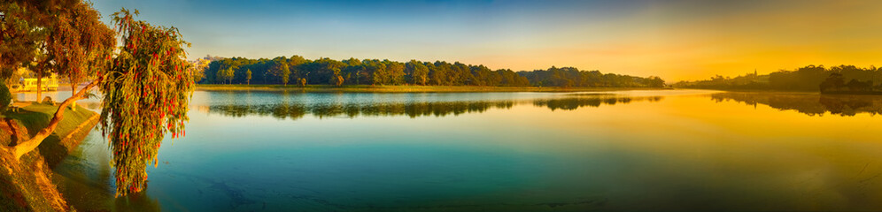 Fototapeta na wymiar Sunrise over Xuan Huong Lake, Dalat, Vietnam. Panorama