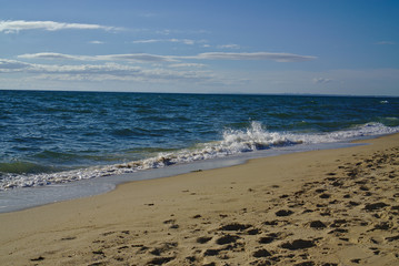 Seashore with blue water and clear sky