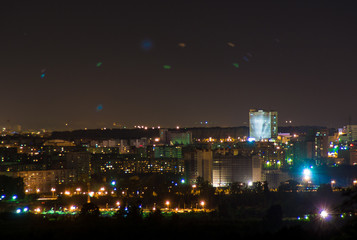Fototapeta na wymiar disco lights in the night city high building
