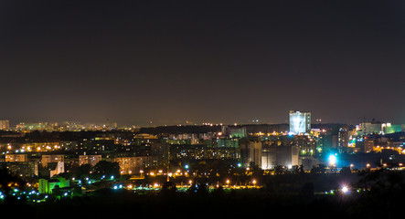 Fototapeta na wymiar night panorama of the city with a high-rise building