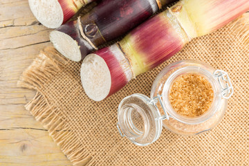 Brown sugar and cane on the table top view
