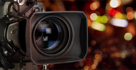 Fototapeta na wymiar Professional video camera on dark background