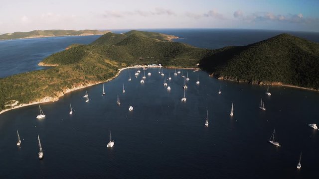 Aerial Forward Slow: Beautiful Norman Island Shoreline With Boats in Norman Island, British Virgin Islands