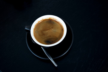 Cup of strong black coffe on wooden table
