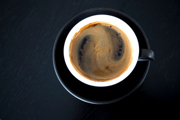 Cup of strong black coffe on wooden table