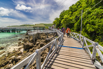 The wooden bridge, walk the beach, go to the pier to transport tourists on the island. Trees on the road on a clear day
