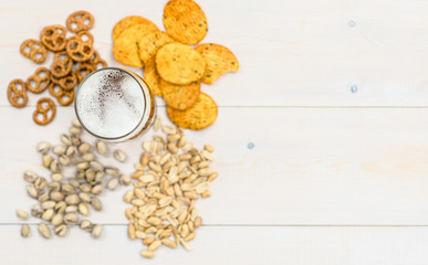 Beer and snacks on wooden background. Empty space for text