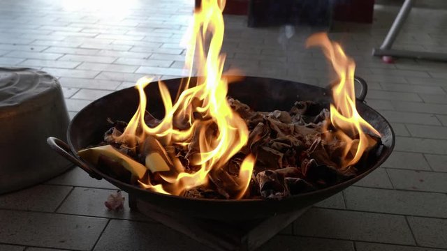 Medium shot burning joss paper.