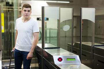 Passenger near baffle gate  in underground