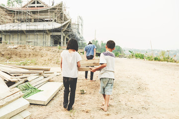 Children working at construction site for world day against children labour concept: