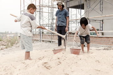 Children working at construction site for world day against child labour concept: