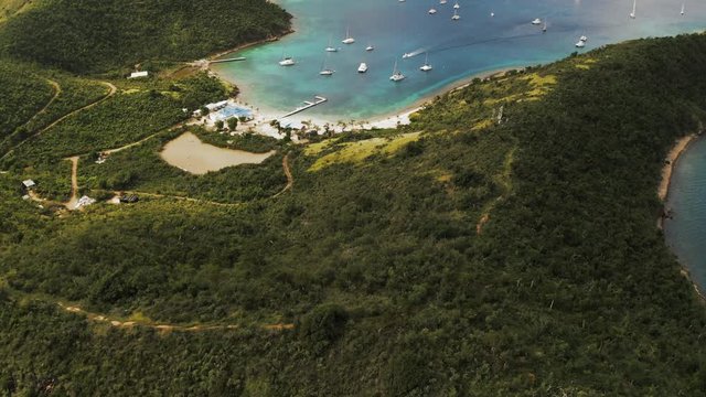 Aerial Descending Slow: Beautiful Bay of Norman Island With Boats Docking in Norman Island, British Virgin Islands