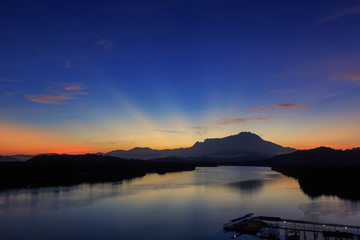 Amazing Beautiful Twilight Sunrise with Rays of light and Mount Kinabalu as background at Gayang, Tuaran, Sabah, Borneo