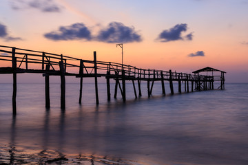 Fototapeta na wymiar Abstract Old wooden jetty pier long exposure during beautiful sunset