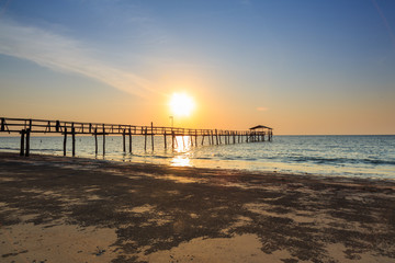 Fototapeta premium Abstract Old wooden jetty pier long exposure during beautiful sunset