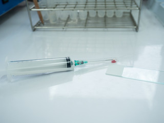 Close up doctor hand holding syringe during smear fine needle aspiration (FNA) from specimen...