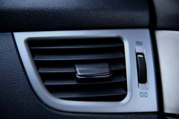 Obraz na płótnie Canvas Air ducts, deflector panel with switch in the car. Car conditioner. The air flow inside the car.