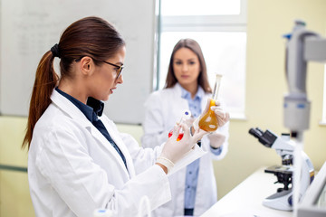 Two womans in laboratory working on analyse with instruments
