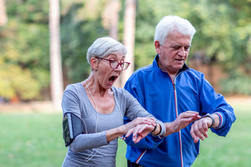 Two aged couple jogging in park