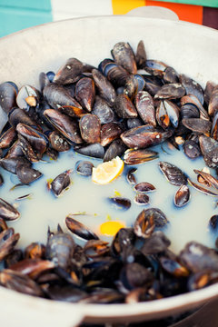 Shellfish Mussels in copper bowl with lemon and herbs