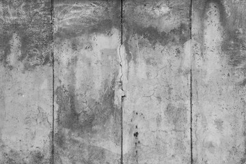 Close-up of a weathered and aged concrete wall in black and white. Full frame texture background of the original Berlin Wall.