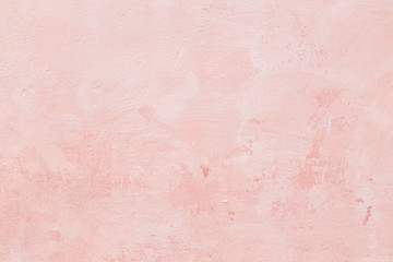 Close-up of a stone or concrete wall painted in pink, paint slightly peeled off. Full frame texture...