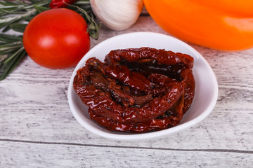 Dried tomatoes in the bowl with olive oil