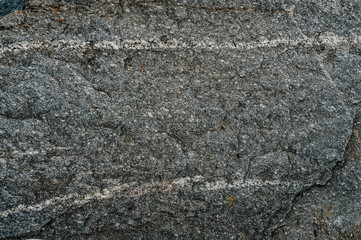 Stone texture background. The surface of granite and basalt. a large rock, a stone wall. close up. place for text.