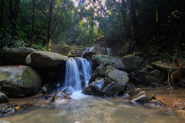 Naklejka na ściany i meble Hidden Beautiful waterfall in the Forrest, Beautiful waterfall with green moss 